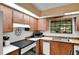 Traditional kitchen with wood cabinets, laminate countertops, and window at 127 Oak Ln, Ormond Beach, FL 32174