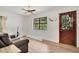 Well-lit living room featuring hardwood floors, comfortable furniture, and a charming view from the window at 127 Oak Ln, Ormond Beach, FL 32174