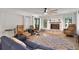 Cozy living room with a brick fireplace, hardwood floors, and large windows at 127 Oak Ln, Ormond Beach, FL 32174