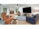Spacious living room with a large television, wood floors, and a cozy brick fireplace at 127 Oak Ln, Ormond Beach, FL 32174
