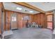 Spacious porch with wood paneled walls and a sturdy gray tile floor at 127 Oak Ln, Ormond Beach, FL 32174