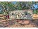 Backyard storage shed with wooden fence and a trailer, enhancing the functionality of the property at 127 Oak Ln, Ormond Beach, FL 32174