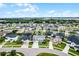 Aerial view of neighborhood homes in a suburban community marked with a map pin, some with solar panels at 13194 Magnolia Valley Dr, Clermont, FL 34711