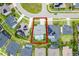 Aerial shot of home with pool surrounded by manicured lawn, solar panels, and a clean driveway with neighboring homes at 13194 Magnolia Valley Dr, Clermont, FL 34711