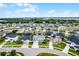 Aerial view of neighborhood homes in a suburban community. Some of the houses have solar panels on the roof at 13194 Magnolia Valley Dr, Clermont, FL 34711