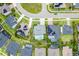 Aerial shot showcasing homes with pools and solar panels nestled within a well-manicured, green neighborhood layout at 13194 Magnolia Valley Dr, Clermont, FL 34711