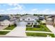 Spacious two-story home with a three-car garage, lush lawn, and beautiful landscaping in a residential neighborhood at 13194 Magnolia Valley Dr, Clermont, FL 34711