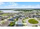 Aerial view of neighborhood homes in a suburban community near a lake, showcasing the community's location at 13194 Magnolia Valley Dr, Clermont, FL 34711