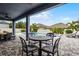 Outdoor seating area with a table and chairs overlooking the beautiful backyard pool at 13194 Magnolia Valley Dr, Clermont, FL 34711
