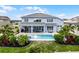 Aerial view of a backyard with a pool, patio, and lush landscaping, creating a private outdoor oasis at 13194 Magnolia Valley Dr, Clermont, FL 34711
