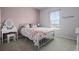 Charming bedroom with pink accent wall and furniture, and natural light from the window at 13194 Magnolia Valley Dr, Clermont, FL 34711