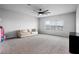 Large bonus room with neutral paint, a ceiling fan, a large window, and plush carpet at 13194 Magnolia Valley Dr, Clermont, FL 34711