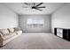 Spacious bonus room with plush carpet, large window, ceiling fan, and neutral paint at 13194 Magnolia Valley Dr, Clermont, FL 34711