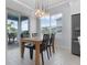 Bright dining area features a modern light fixture above the wood table, and sliding glass doors to the outdoor patio at 13194 Magnolia Valley Dr, Clermont, FL 34711