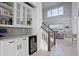 Stylish entryway with a staircase, shiplap walls, and a convenient wet bar area for entertaining at 13194 Magnolia Valley Dr, Clermont, FL 34711