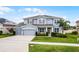 Beautiful two-story home featuring a three car garage, well-manicured lawn and lovely landscaping at 13194 Magnolia Valley Dr, Clermont, FL 34711