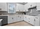 Modern kitchen featuring white cabinets, stainless steel appliances, and sleek hardware at 13194 Magnolia Valley Dr, Clermont, FL 34711