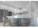 Modern kitchen with white cabinetry, stainless steel appliances, and a large island with pendant lighting at 13194 Magnolia Valley Dr, Clermont, FL 34711