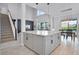 Open-concept kitchen, living, and dining area featuring modern fixtures and an abundance of natural light at 13194 Magnolia Valley Dr, Clermont, FL 34711