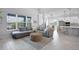 Cozy living room with an open layout to the kitchen, large windows, and a comfortable sectional sofa at 13194 Magnolia Valley Dr, Clermont, FL 34711