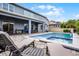 Charming patio view of the pool and spa with lounge chairs, creating a relaxing backyard retreat at 13194 Magnolia Valley Dr, Clermont, FL 34711
