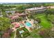 Aerial view showcasing the community's swimming pool, outdoor lounge areas, clubhouse, and lush, mature landscaping at 14 Camino Real Blvd # 14, Howey In The Hills, FL 34737