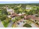 Aerial view of the club and resort showing its proximity to the golf course, water features, and manicured landscaping at 14 Camino Real Blvd # 14, Howey In The Hills, FL 34737