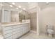 Bathroom with a walk-in shower, vanity with storage, and modern fixtures at 14 Camino Real Blvd # 14, Howey In The Hills, FL 34737