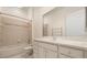 A bathroom featuring a bathtub-shower combo, toilet, and a white vanity with sink, storage and large mirror at 14 Camino Real Blvd # 14, Howey In The Hills, FL 34737