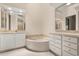 Relaxing bathroom featuring a soaking tub and vanity with storage at 14 Camino Real Blvd # 14, Howey In The Hills, FL 34737