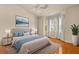 Serene primary bedroom with plush bedding, bay windows, and decorative lighting at 14 Camino Real Blvd # 14, Howey In The Hills, FL 34737