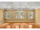Bright bedroom featuring hardwood floors, neutral walls, and large windows with white shutters, offering lots of natural light at 14 Camino Real Blvd # 14, Howey In The Hills, FL 34737