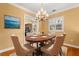 Elegant dining room featuring an oval table with seating for six at 14 Camino Real Blvd # 14, Howey In The Hills, FL 34737