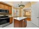 Bright kitchen with stainless steel appliances, center island, and ample counter space at 14 Camino Real Blvd # 14, Howey In The Hills, FL 34737