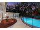 Backyard with a refreshing pool, a screen enclosure, manicured landscaping, and an outdoor entertaining space at 140 Sweet Bay Cir, Lake Mary, FL 32746