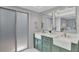 Bathroom featuring a modern double vanity with sleek fixtures and a glass-enclosed shower at 140 Sweet Bay Cir, Lake Mary, FL 32746