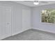 Bedroom with neutral walls, carpeted floors, ceiling fan and a window view of lush foliage at 140 Sweet Bay Cir, Lake Mary, FL 32746