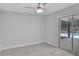 Bedroom with neutral walls, carpeted floors, sliding glass door overlooking the pool and a ceiling fan at 140 Sweet Bay Cir, Lake Mary, FL 32746