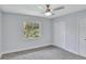 Bedroom with neutral walls, carpeted floors, and a ceiling fan and a window view of greenery at 140 Sweet Bay Cir, Lake Mary, FL 32746