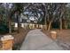 Charming one-story home featuring a brick exterior, dormer windows, and mature trees at 140 Sweet Bay Cir, Lake Mary, FL 32746