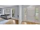 Bright foyer featuring wood flooring, a white paneled door, and plenty of natural light at 140 Sweet Bay Cir, Lake Mary, FL 32746