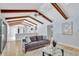 Bright living room featuring wood floors, exposed beam ceiling, and open access to the kitchen at 140 Sweet Bay Cir, Lake Mary, FL 32746