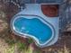 Aerial view of the backyard, sparkling blue pool, and surrounding trees at 140 Sweet Bay Cir, Lake Mary, FL 32746