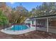 Backyard with refreshing pool, safety fence, screened patio, landscaping, and charming white home at 140 Sweet Bay Cir, Lake Mary, FL 32746