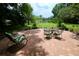 View of a brick back patio with metal chairs, a table, and view of the lake at 1405 Periwinkle Ave, Deland, FL 32724
