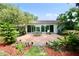 Beautiful brick back patio with sliding glass doors and view of the landscaped backyard at 1405 Periwinkle Ave, Deland, FL 32724