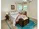 Bedroom with a bed, bedside tables and an area rug at 1405 Periwinkle Ave, Deland, FL 32724