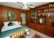 Bedroom with wood paneling and a built-in bookcase, providing ample storage and display space at 1405 Periwinkle Ave, Deland, FL 32724