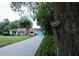 Charming single-story home featuring a brick chimney, turquoise trim, and a well-manicured front yard at 1405 Periwinkle Ave, Deland, FL 32724