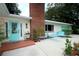 Close-up view of the turquoise front door and brick chimney with seating area at 1405 Periwinkle Ave, Deland, FL 32724